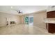 Living room featuring tile floors, fireplace, sliding glass door and ceiling fan at 7324 Phillips St, Sarasota, FL 34243