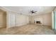 Living room with tile floors, a brick fireplace, ceiling fan and large entrance door at 7324 Phillips St, Sarasota, FL 34243