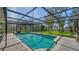 Sparkling pool with screen enclosure and brick paver deck at 7324 Phillips St, Sarasota, FL 34243