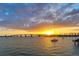 Gorgeous sunset over the water, with boats dotting the horizon, and the iconic Ringling Bridge illuminated at 7324 Phillips St, Sarasota, FL 34243