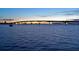 Scenic water view featuring a lit bridge spanning the horizon at dusk and a sailboat sailing in the peaceful water at 7324 Phillips St, Sarasota, FL 34243