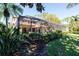 Screened patio and lush landscaping in backyard at 7503 Calle Facil, Sarasota, FL 34238