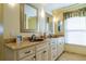 Elegant bathroom with double vanity, copper sinks, and large mirror at 7503 Calle Facil, Sarasota, FL 34238