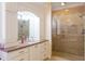 Bathroom with granite countertop, white cabinets, and glass shower at 7503 Calle Facil, Sarasota, FL 34238