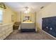 Bedroom with a full-size bed, ceiling fan, and a chalkboard accent wall at 7503 Calle Facil, Sarasota, FL 34238