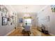 Bright dining room with hardwood floors and a chandelier at 7503 Calle Facil, Sarasota, FL 34238