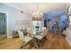 Elegant dining room featuring a glass table, chandelier, and hardwood floors at 7503 Calle Facil, Sarasota, FL 34238