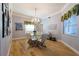 Formal dining room featuring hardwood floors and chandelier at 7503 Calle Facil, Sarasota, FL 34238