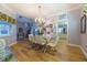 Bright dining room with hardwood floors and view into kitchen at 7503 Calle Facil, Sarasota, FL 34238