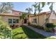 Beautiful two-story home with lush landscaping and a walkway to the entrance at 7503 Calle Facil, Sarasota, FL 34238