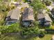 Aerial view of three homes with private pools and lush landscaping at 7755 Pine Trace Dr # 7755, Sarasota, FL 34243