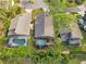 Aerial view of three homes with private pools and lush landscaping at 7755 Pine Trace Dr # 7755, Sarasota, FL 34243