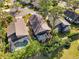 Aerial view showing three homes with screened pools and green surroundings at 7755 Pine Trace Dr # 7755, Sarasota, FL 34243