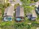 Aerial view of three homes with private pools and lush landscaping at 7755 Pine Trace Dr # 7755, Sarasota, FL 34243