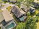 Aerial view highlighting the home's backyard oasis, featuring a pool and screened enclosure at 7755 Pine Trace Dr # 7755, Sarasota, FL 34243