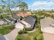 Aerial view of single-Gathering home with attached garage and landscaped yard at 7755 Pine Trace Dr # 7755, Sarasota, FL 34243