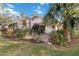 Landscaped backyard with patio, pool, and lush greenery at 7755 Pine Trace Dr # 7755, Sarasota, FL 34243