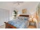 Bedroom with a wooden bed frame and coastal decor at 7755 Pine Trace Dr # 7755, Sarasota, FL 34243