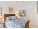 Bright bedroom with wooden bed frame and coastal decor at 7755 Pine Trace Dr # 7755, Sarasota, FL 34243