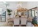 Bright dining area with antique cabinet and modern chandelier at 7755 Pine Trace Dr # 7755, Sarasota, FL 34243