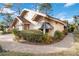 Tan house with gray awnings and a brick walkway at 7755 Pine Trace Dr # 7755, Sarasota, FL 34243