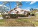 Tan house with gray awnings and a brick walkway at 7755 Pine Trace Dr # 7755, Sarasota, FL 34243