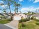 Tan house with white garage door and manicured landscaping at 7755 Pine Trace Dr # 7755, Sarasota, FL 34243