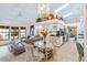 Open concept kitchen and dining area with stylish chandelier at 7755 Pine Trace Dr # 7755, Sarasota, FL 34243