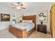 Spacious main bedroom with leather bed, ceiling fan and bathroom access at 7755 Pine Trace Dr # 7755, Sarasota, FL 34243