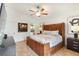 Large main bedroom with leather bed, ceiling fan and plenty of natural light at 7755 Pine Trace Dr # 7755, Sarasota, FL 34243