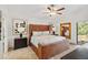 Large main bedroom with leather bed, ceiling fan and plenty of natural light at 7755 Pine Trace Dr # 7755, Sarasota, FL 34243