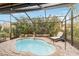 Relaxing screened pool and patio area with lounge chair at 7755 Pine Trace Dr # 7755, Sarasota, FL 34243