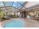 Enclosed pool and patio area with lounge chair and seating at 7755 Pine Trace Dr # 7755, Sarasota, FL 34243