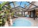 Enclosed pool and patio area with lounge chair and seating at 7755 Pine Trace Dr # 7755, Sarasota, FL 34243