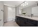 Well-lit bathroom with double vanity and bathtub at 8208 Carrhill Pl, Parrish, FL 34219