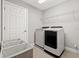 Convenient laundry room with washer, dryer, and storage at 8208 Carrhill Pl, Parrish, FL 34219