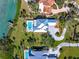 Aerial view of a home with a pool, manicured lawn and large driveway at 935 Bayshore Rd, Nokomis, FL 34275