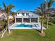 Aerial view of a gorgeous backyard featuring a pool and an outdoor living space at 935 Bayshore Rd, Nokomis, FL 34275