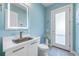 Charming powder room featuring a unique vessel sink, modern mirror and stylish lighting at 935 Bayshore Rd, Nokomis, FL 34275