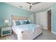 Cozy bedroom with a woven bed frame, soft blue accents, and light wood flooring at 935 Bayshore Rd, Nokomis, FL 34275