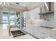 Well-lit kitchen with a view, stainless steel appliances, white cabinetry, and sleek countertops at 935 Bayshore Rd, Nokomis, FL 34275