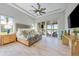 Serene main bedroom featuring a tray ceiling, neutral tones, and access to a private balcony at 935 Bayshore Rd, Nokomis, FL 34275