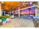 Spacious covered patio with outdoor kitchen and dining area overlooking the water at 935 Bayshore Rd, Nokomis, FL 34275