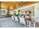 Expansive outdoor kitchen and dining area flows to the indoor living space with easy access to the pool and waterfront at 935 Bayshore Rd, Nokomis, FL 34275