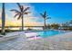 Tranquil waterfront pool features fountains, elegant tile surround, and relaxing lounge chairs on the deck at 935 Bayshore Rd, Nokomis, FL 34275