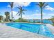 Stunning pool with waterfront views and lush tropical landscaping is an ideal location to relax at 935 Bayshore Rd, Nokomis, FL 34275