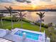 Modern pool and waterfront view, perfect for outdoor relaxation at 935 Bayshore Rd, Nokomis, FL 34275