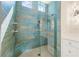 Stunning blue tiled shower with rainfall shower head and body sprayers at 935 Bayshore Rd, Nokomis, FL 34275