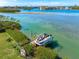 Waterfront home featuring a boat dock and lift with access to scenic waterways at 935 Bayshore Rd, Nokomis, FL 34275