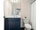 Clean bathroom with blue vanity, white subway tile, and hexagon floor at 1012 Fernleaf Run, Bradenton, FL 34212